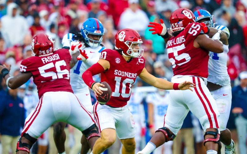 AI-assisted summary
No. 8 Mississippi’s win over No. 11 Oklahoma has essentially secured the Rebels a spot in the College Football Playoff.
Oklahoma’s playoff chances are slim after the loss, and the team faces a difficult schedule to close out the season.
Vanderbilt, Brigham Young, and Iowa were among the weekend’s biggest winners, with each team improving its postseason outlook.
No. 8 Mississippi’s 34-26 win against No. 11 Oklahoma is essentially a College Football Playoff clincher for the Rebels, who avoided a second loss in as many weeks and close with South Carolina, The Citadel, Florida and Mississippi State.
While they’ll be expected to run the table in November, the Rebels could likely survive a second loss and earn an at-large berth. Not so for Oklahoma, which may needs to win out against a brutal four-game run to cap the regular season.
No team in the Bowl Subdivision will have it tougher down the stretch. The Sooners will play No. 17 Tennessee and No. 4 Alabama on the road and then face No. 14 Missouri and No. 19 LSU at home.
The odds of a playoff berth are growing increasingly slim. A more pertinent question with a crucial run ahead: Can the Sooners and Brent Venables salvage some lost momentum with a strong November and at a minimum avoid a highly scrutinized offseason?
Doing so would require some major growth from an offense that has cratered after a strong start, in no small part because of an injury to quarterback John Mateer. While he missed only the Kent State win, the Washington State transfer has two touchdowns against three interceptions and just 36 rushing yards in his past three games.
And while the defense has helped carry the load, the Rebels gained 431 yards and ran 87 plays, eventually wearing down the Sooners’ defense and owning the fourth quarter.
There needs to be a recalibration of expectations. This isn’t an elite team, the earlier win against No. 24 Michigan notwithstanding; the Wolverines would probably be favored if the two teams met next Saturday. Oklahoma is a pretty good team in a brutal conference that chews up and spits out good teams.
At this point, the Sooners have to win at least one and likely two games in November to develop some momentum heading into what should be a make-or-break 2026 season for Venables.
Oklahoma and Vanderbilt lead Saturday’s biggest winners and losers:
Winners
Vanderbilt
This is the world we live in: No. 2 Indiana is an absolute behemoth and No. 10 Vanderbilt is pretty damn good, too. The Commodores scored one of the biggest regular-season wins in program history by beating Missouri 17-10, securing the victory with a late defensive stand after taking the lead on a Diego Pavia touchdown run with under two minutes to play. Now 7-1 and with beleaguered Texas up next, Vanderbilt is inching closer to an unexpected playoff berth that would speak to the wildly increased level of parity in the Power Four. Pavia had 149 yards of offense and that one score while Missouri lost starting quarterback Beau Pribula to an injury early in the second half.
Texas A&M
No. 3 A&M actually trailed LSU 18-14 at halftime, which makes it even more ridiculous to see the Aggies lead 35-18 with four minutes left in the third quarter. This 49-25 win was a story of two programs heading into opposite directions: LSU is down, down, down under Brian Kelly while the Aggies are flourishing in a major way under second-year coach Mike Elko. The highly impressive third quarter showed that A&M is not just capable of winning the SEC but the whole thing, too, especially with the way the offense, defense and special teams worked in concert to bulldoze hapless LSU. At this point, the Aggies are everything the Tigers are not.
Brigham Young
Unbeaten but still not taken too seriously as a legitimate contender, No. 10 Brigham Young climbed out of a pair of double-digit holes in the first half and scored a 41-27 win at Iowa State behind an eye-opening game from freshman Bear Bachmeier. While the Cyclones turned the ball over four times, including three interceptions from Rocco Becht, Bachmeier threw for 307 yards, ran for a team-high 49 yards and had three combined touchdowns with no giveaways. Being plus-four in turnovers meant the difference for the Cougars, who were outgained overall and gave up 184 yards on the ground. Now 8-0, BYU has turned a corner as a program the past two seasons.
Iowa
While a shot the Big Ten crown is unlikely given an earlier loss to No. 2 Indiana, the recipe is coming together for Iowa just in time to make a serious run at an at-large playoff bid. The Hawkeyes combined an elite defense, a largely error-free performance on offense and opportunistic special teams to swamp Minnesota 41-3, continuing an outright ownership of this rivalry. (Some Big Ten math: Iowa is to Minnesota what Minnesota is to Nebraska, but Iowa is also to Nebraska what Minnesota is to Nebraska, if that makes sense.) Iowa got started with a 75-yard touchdown drive on the game’s opening possession and then scored on a pick-six and a punt return to lead 31-0 at halftime.
Houston
The Cougars are for real in coach Willie Fritz’s second season. (He’s won everywhere else he’s been, so we’re not surprised.) While No. 25 Arizona State made things tight by scoring 16 points in the fourth quarter, beating the Sun Devils 24-16 in Tempe might be the program’s best wins in years given how firmly Houston is now set as one of the top contenders in the Big 12 heading into November.
Losers
UCLA
Nico Iamaleava was sacked on the first play of scrimmage, tossed a pick-six a play later and things didn’t get much better for UCLA, which completely outclassed in a 56-6 loss to Indiana that snapped a three-game winning streak in Big Ten play. Iamaleava completed 13 of 27 throws for 113 yards and had two interceptions as the Hoosiers held UCLA to just 201 yards on 3.8 yards per play. While not unexpected, the loss does reveal the Bruins’ inherent flaws heading into games against Nebraska, No. 1 Ohio State, Washington and Southern California to end the regular season.
Brian Kelly
Red-faced and furious Brian Kelly we know. But we’re becoming more familiar with where-am-I-and-what’s-happening Brian Kelly, who had blank stares and few words as A&M was driving his team into the ground in the second half. That he’s running out of answers means LSU is running out of time and patience with a coach who is destined to become the first since Gerry DiNardo to not win a national championship with the Tigers.
Bill Belichick
Moral victories aren’t why UNC is paying a six-time Super Bowl champion $10 million per season. But that’s where we are with the Tar Heels, who fought and clawed to hang with No. 16 Virginia – just like California the week before – but lost 17-16 in overtime to fall to 2-5 overall and 0-3 in the ACC. The defense has made some nice gains since the opener against TCU, but the UNC offense is a punchless and inept group that will clearly need to be redone this offseason. The big question: Will Belichick be around for the overhaul?
SMU
Wake Forest drilled a 50-yard field goal with no time left and topped SMU 13-12 to snap the Mustangs’ 20-game winning streak in regular-season conference games, the longest streak in the FBS. Now with a loss in conference and three overall, SMU can only make a return trip to the playoff by winning out – and getting a little bit of help along the way – to reach the ACC championship game. That’s good news for Arkansas, which has zeroed in on SMU coach Rhett Lashlee to replace Sam Pittman and could make that hire official in early December instead of waiting until later in the month.
South Florida
The No. 20 Bulls led Memphis 21-7 in the second quarter, 24-14 at halftime and 31-17 heading into the fourth quarter but lost 34-31 after missing a 52-yard field goal as time expired. This is an awful loss for a team that went into the weekend atop the American and in the driver’s seat for the Group of Five’s guaranteed playoff bid. It’s also hard to see how this happened: USF racked up 564 yards overall, ran for 295 yards on 7.8 yards per carry, held Memphis just 3.8 yards per carry and converted 12 of 18 third-down attempts. The loss drops the Bulls a game behind Navy in the conference standings.
This post appeared first on USA TODAY Oklahoma, Vanderbilt lead college football Week 9 winners and losers